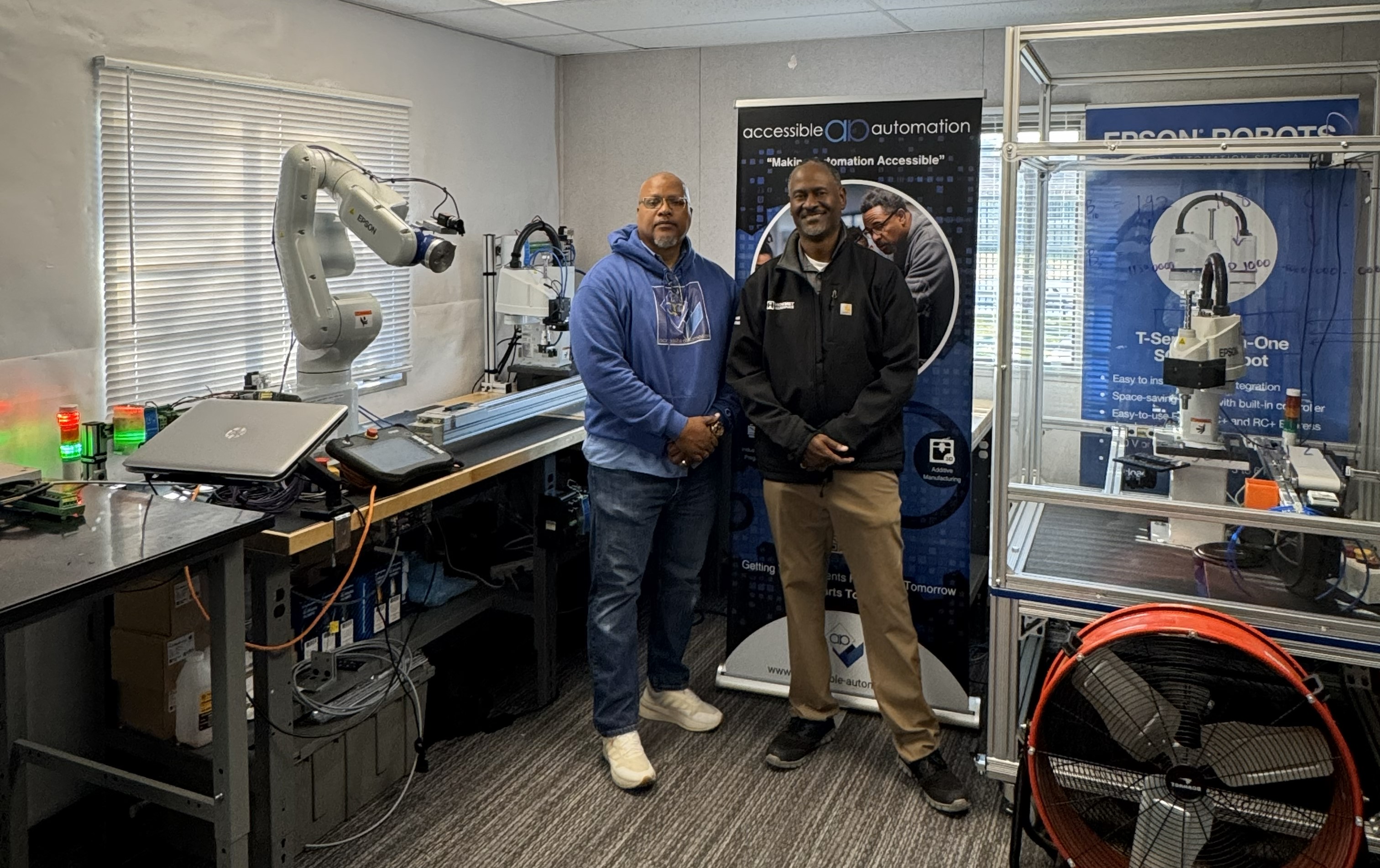An AAI founder with an industry partner in the AAI automation lab