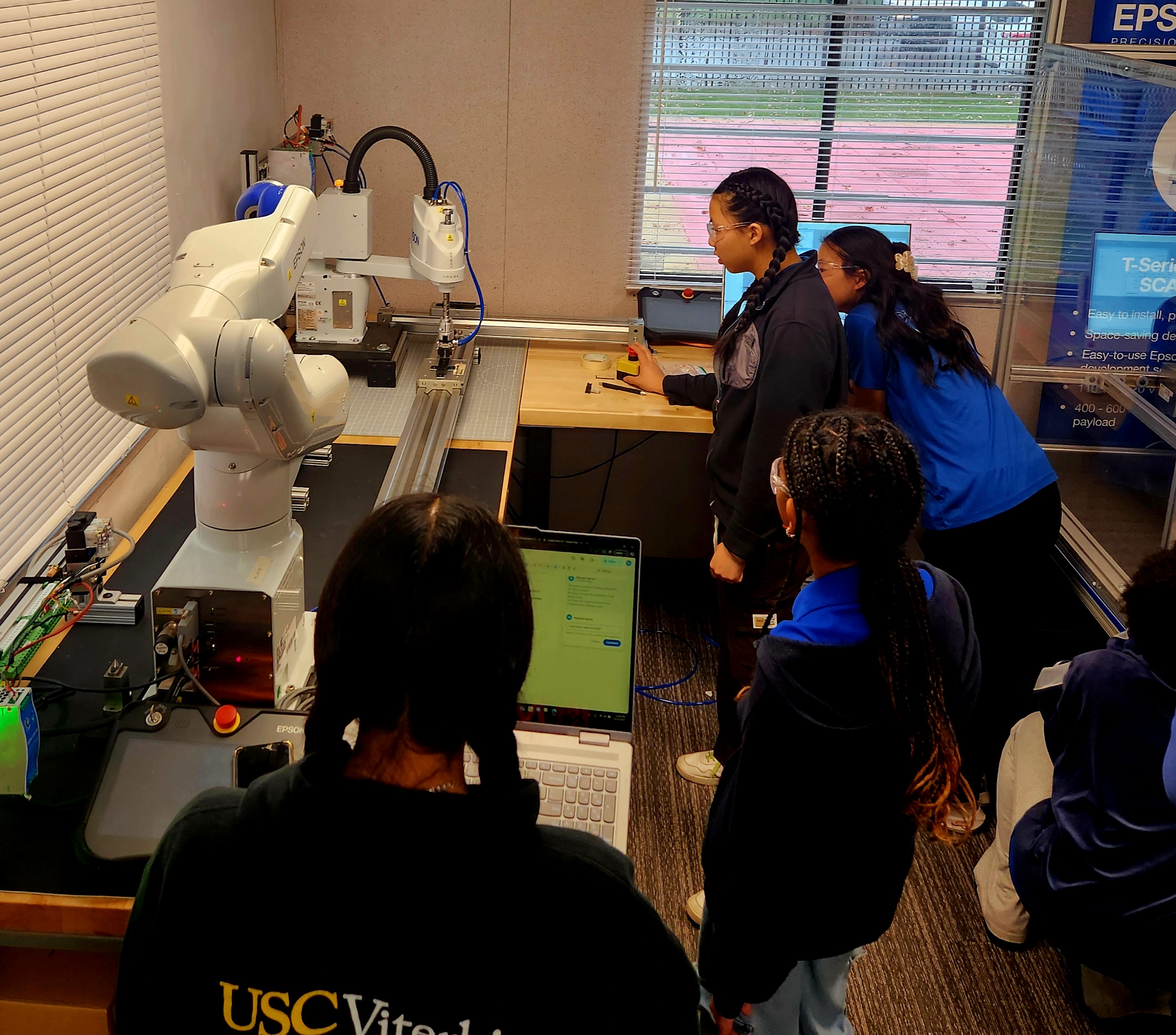 Students working at an Epson SCARA robot cell during an AAI industry visit